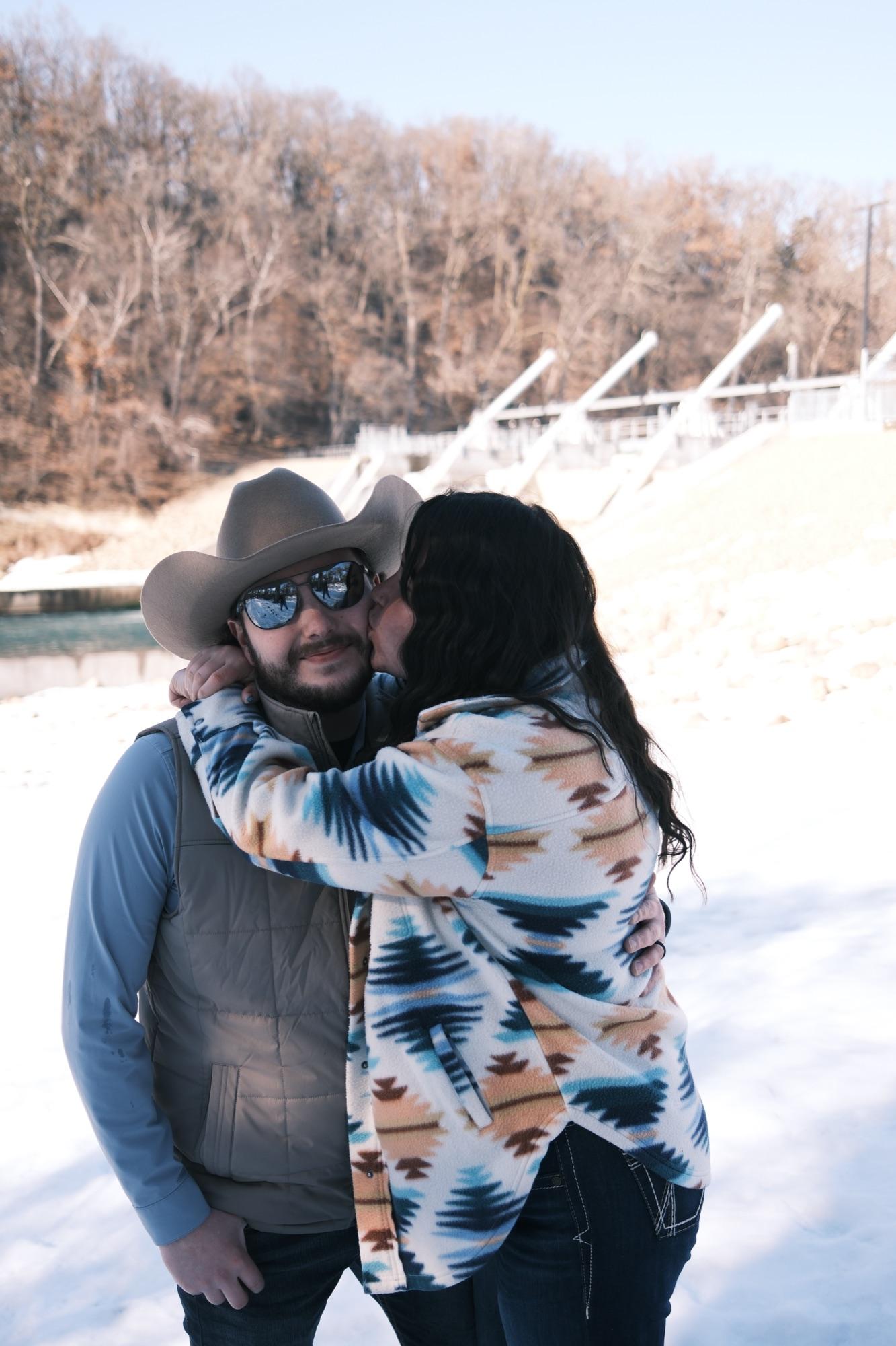 Cowboy-hat hug — warm winter couples session