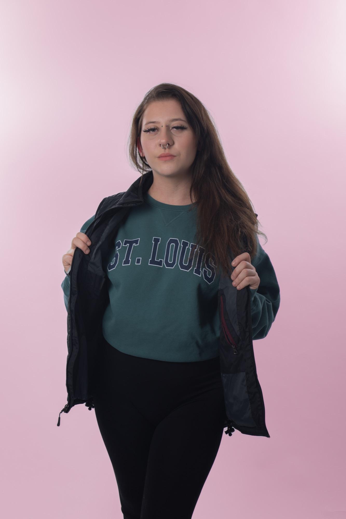 Editorial studio portrait on pink — St. Louis crewneck reveal