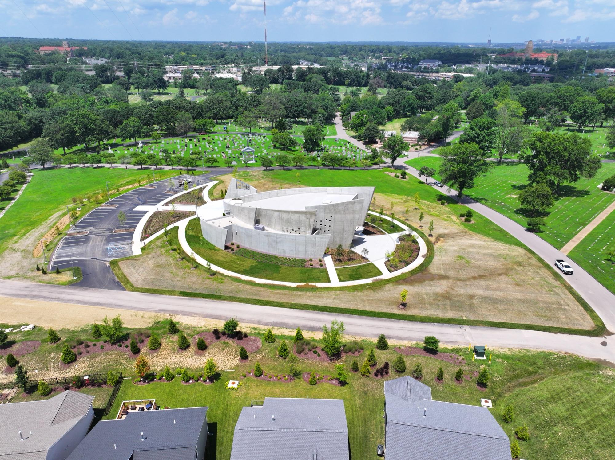 Completed BSI chapel from the air — sculpted concrete in a ring of new landscaping and walkways