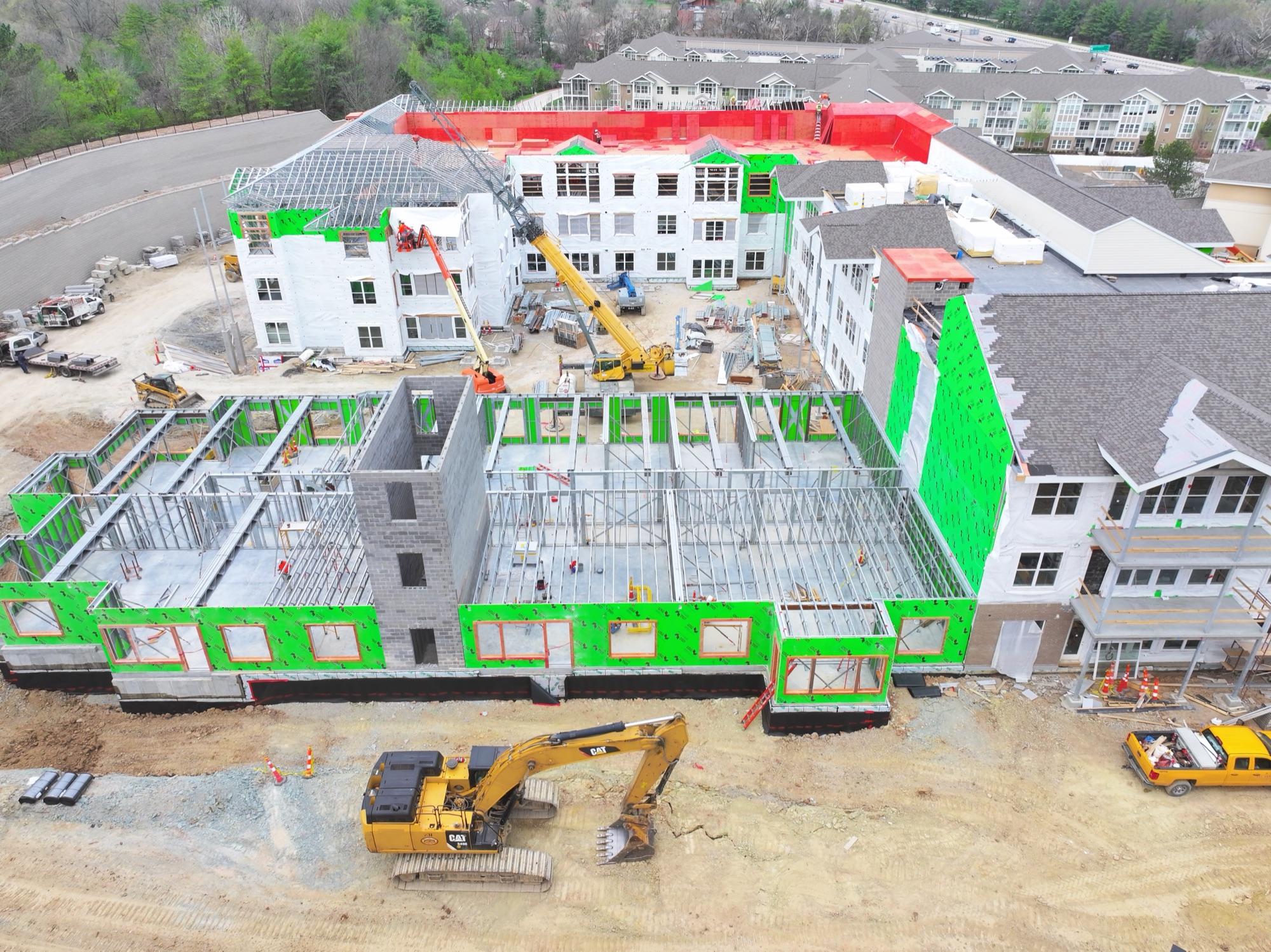 Mason Pointe expansion — steel framing rising beside occupied senior-living buildings
