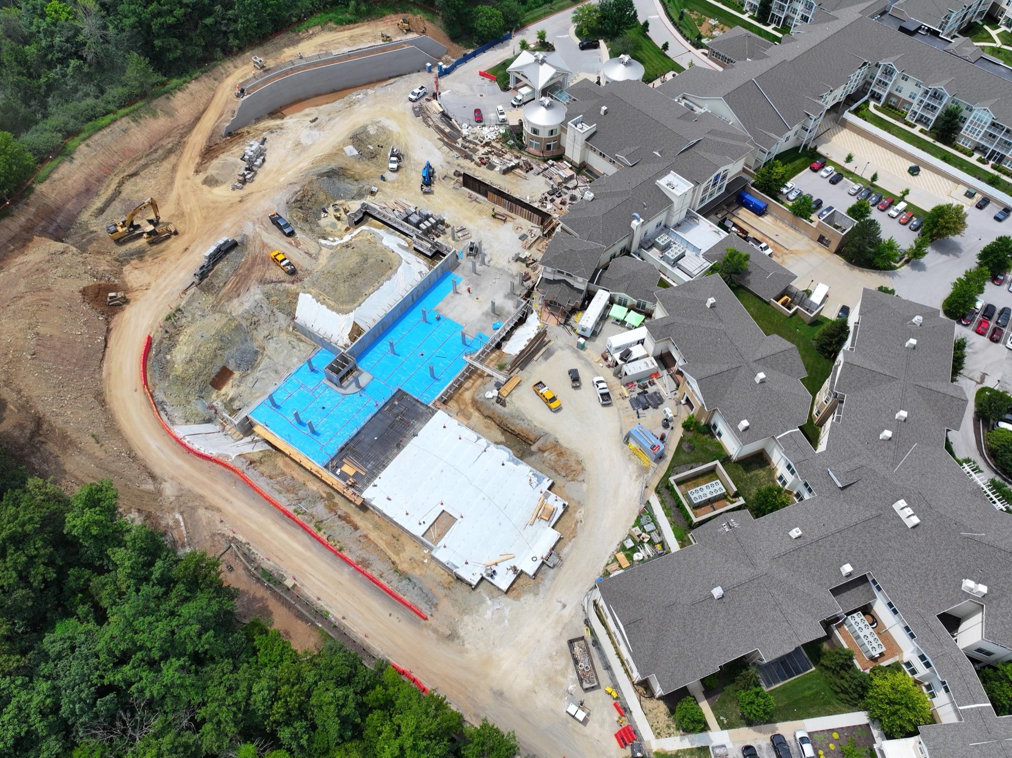 Mason Pointe senior-living campus aerial — new construction phase beside the occupied community