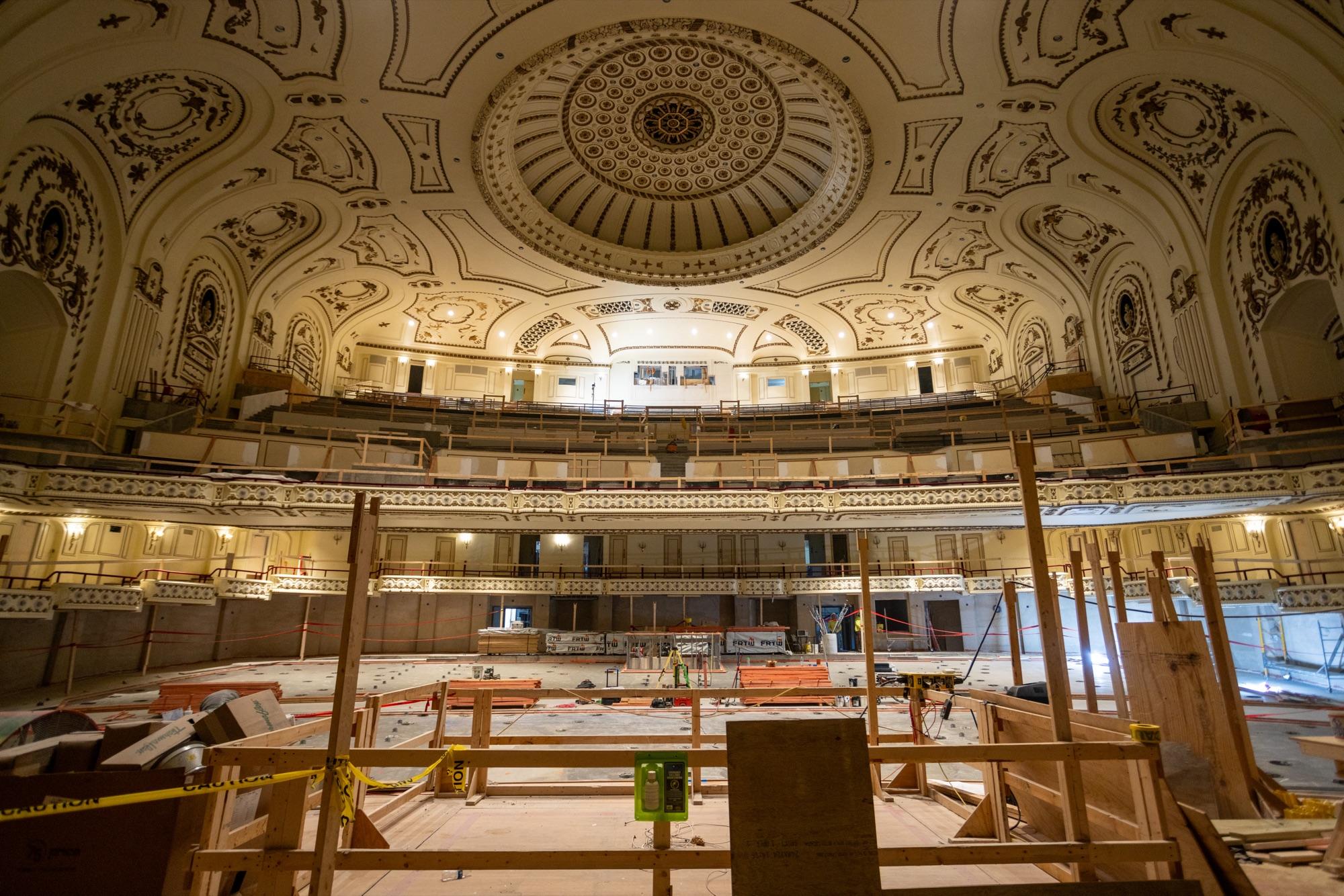 Ornate theater dome wrapped in scaffolding mid-restoration