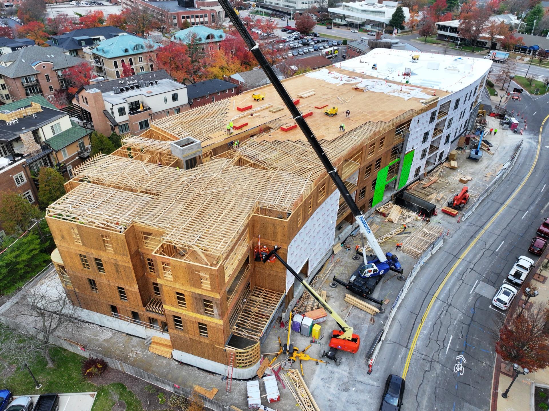 Multi-story building under construction with crane — progress documentation