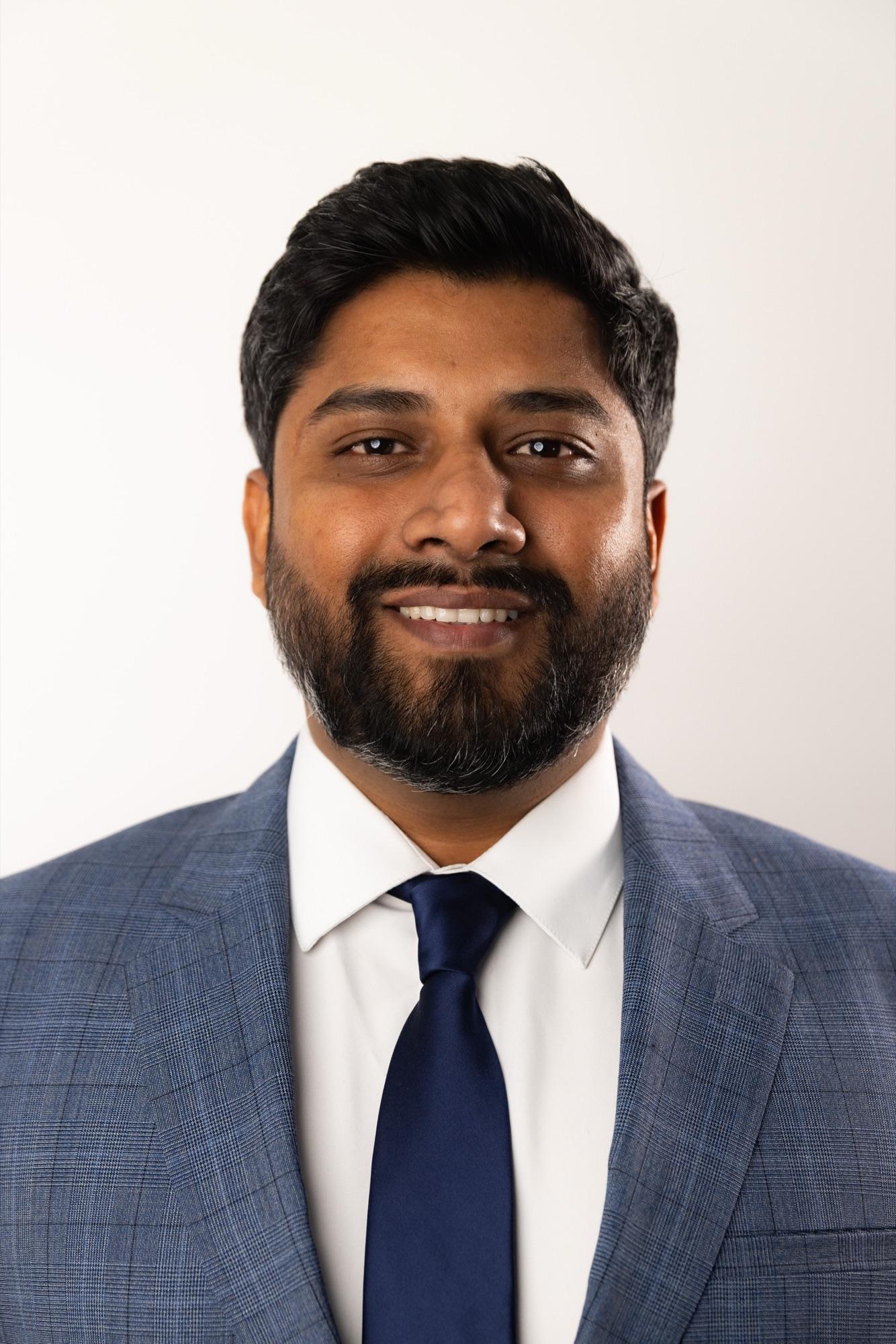 Studio business headshot in navy on clean white