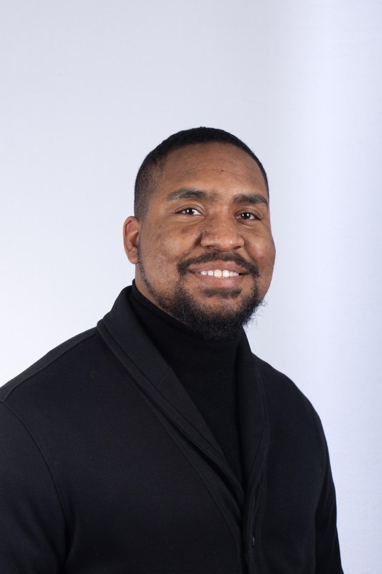Studio headshot in black on white seamless